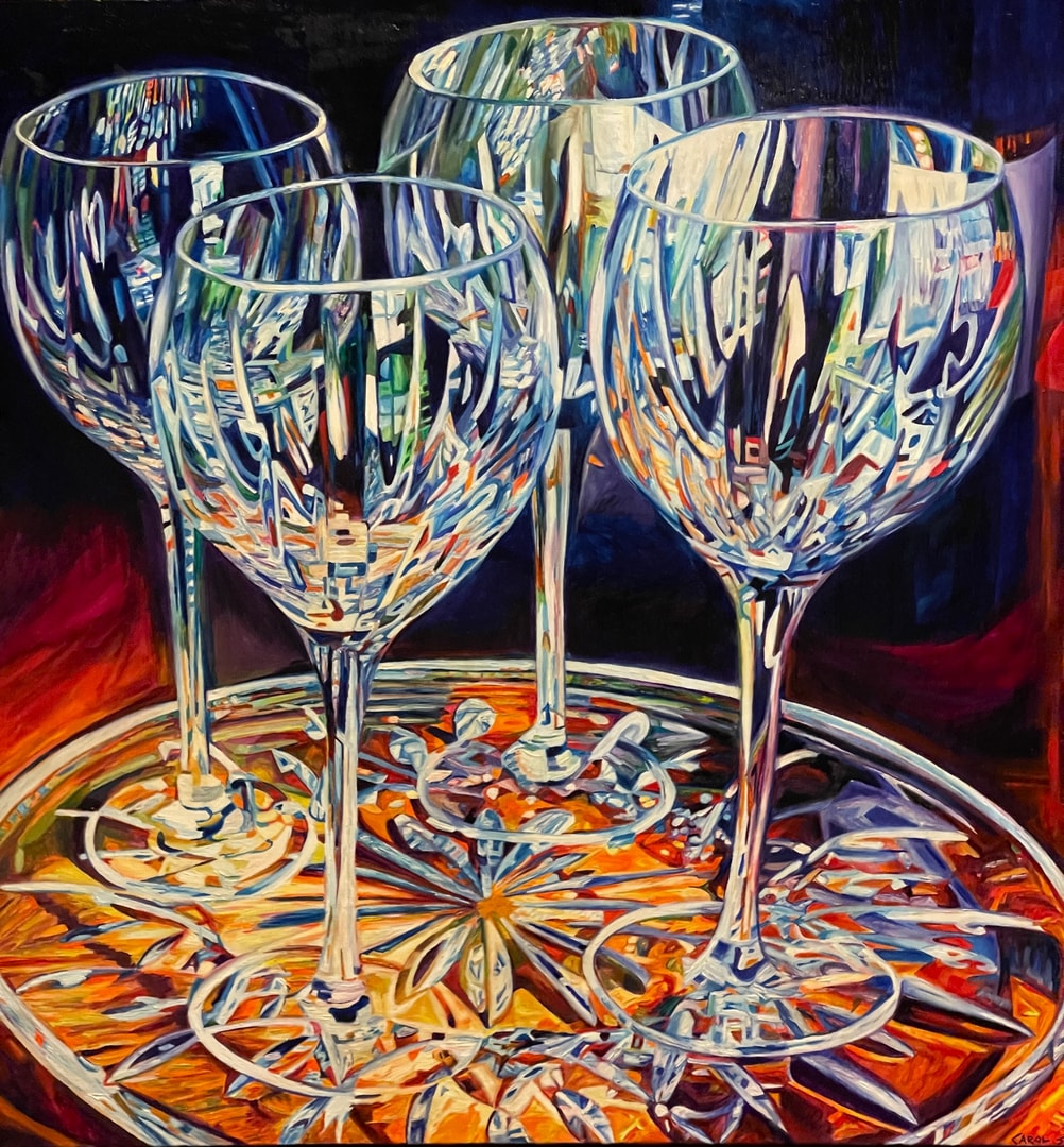 Wine glasses on decorative plate against dark background