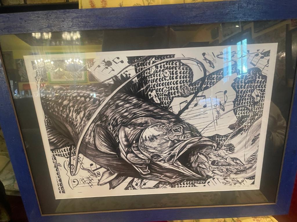 Framed black and white print of fish with musical notes