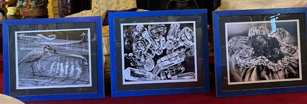 Three framed black and white prints displayed together